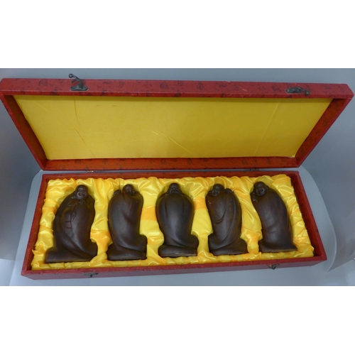 1005 - Five wooden Buddha figures, cased