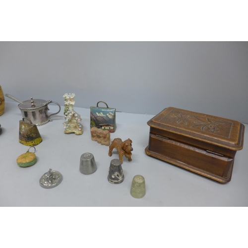 679 - A carved wooden box, a carved dog, two souvenir cow bells, a plated mustard, etc.