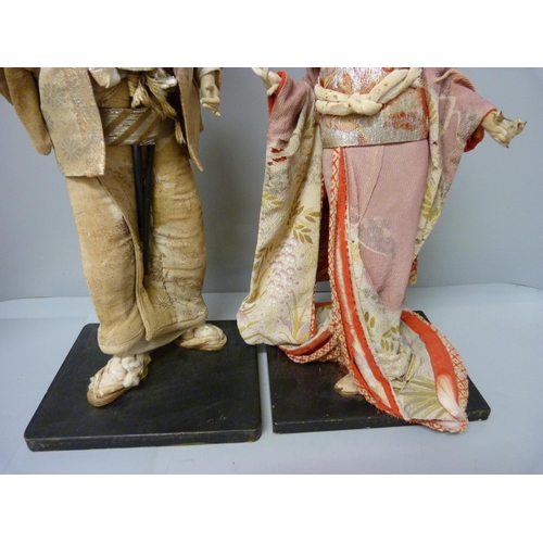 799 - Two Japanese figures dressed in traditional dress, a/f, 43cm