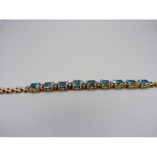 915 - An 18ct gold, blue topaz and diamond bracelet, 14.5g, 18cm