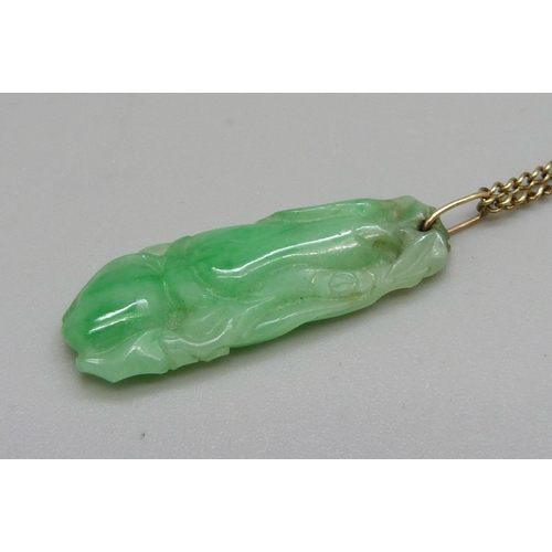 918 - A carved jade pendant on a 9ct gold chain, chain 3.2g and 49cm