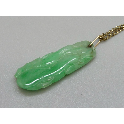 918 - A carved jade pendant on a 9ct gold chain, chain 3.2g and 49cm