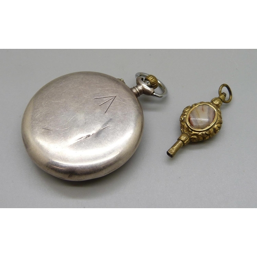 960 - A Tavanne's pocket watch with broad arrow to the case back, dial a/f and an agate set watch key