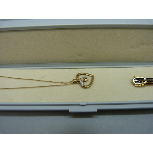 962 - A 9ct gold pendant and chain, 1.4g, a German cat pendant marked 333, 3.8g, and a mother of pearl gui... 