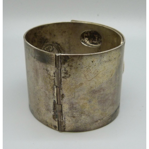 963 - A large hinged bangle, marked 900, 114g