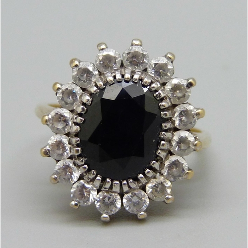 981 - A 9ct gold cluster ring set with an approximately 1.78ct sapphire and white stones, 5.1g, L