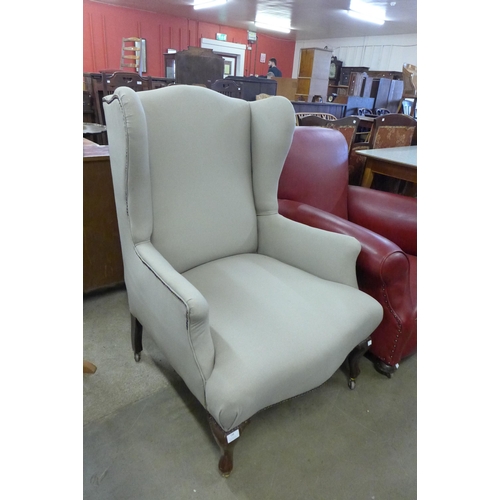 218 - A late Victorian mahogany and fabric upholstered wingback armchair