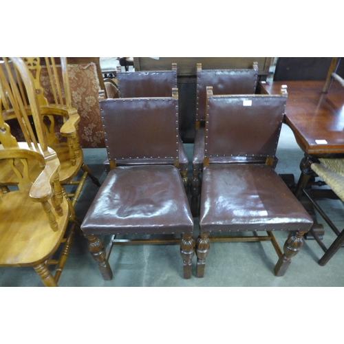 223 - A set of four oak and brown leather dining chairs