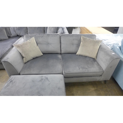 1460 - A grey velvet three seater sofa and footstool