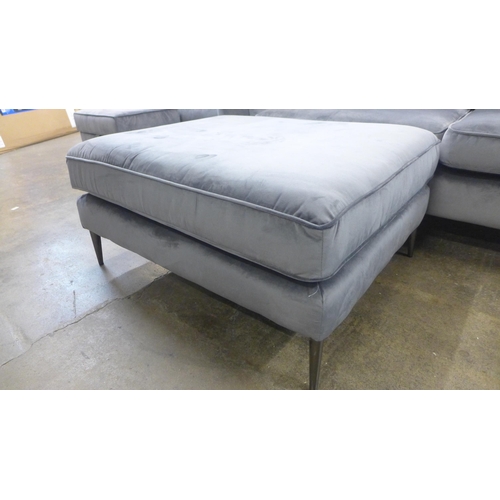 1460 - A grey velvet three seater sofa and footstool