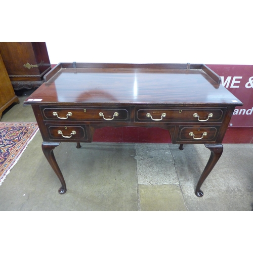 104 - An Edward VII mahogany four drawer writing table