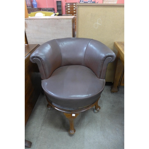 154 - An Edward VII mahogany and brown vinyl revolving library chair