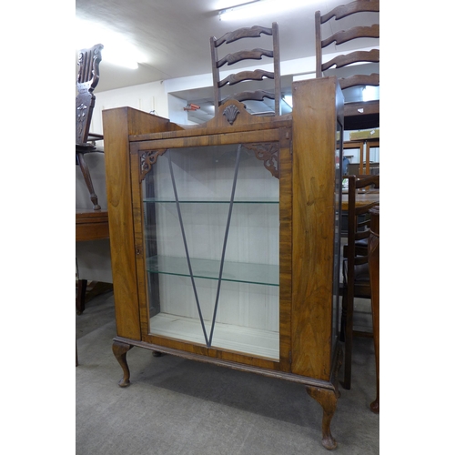 184 - An early 20th Century walnut display cabinet