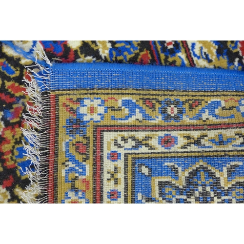 186 - A large blue ground rug, 375 x 280cms