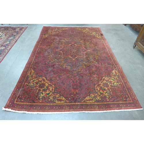 191 - An early 20th Century Persian red ground Herris rug, 280 x 185cms