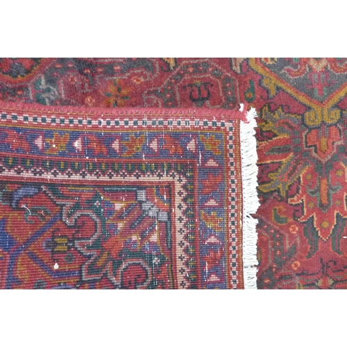 191 - An early 20th Century Persian red ground Herris rug, 280 x 185cms