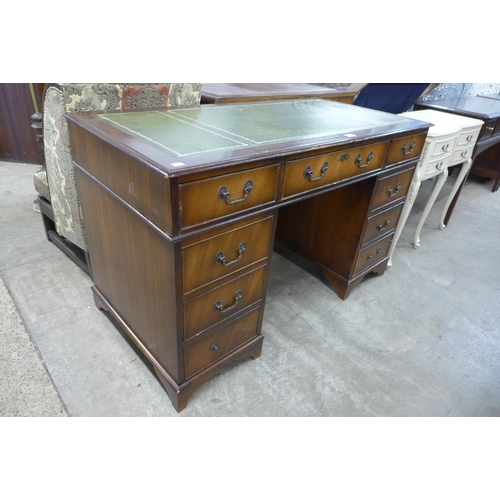 194 - A mahogany and green leather topped pedestal desk