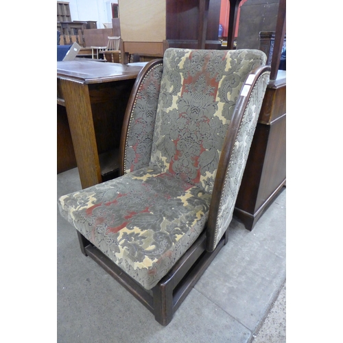 214 - An early 20th century beech and fabric upholstered lambing style chair