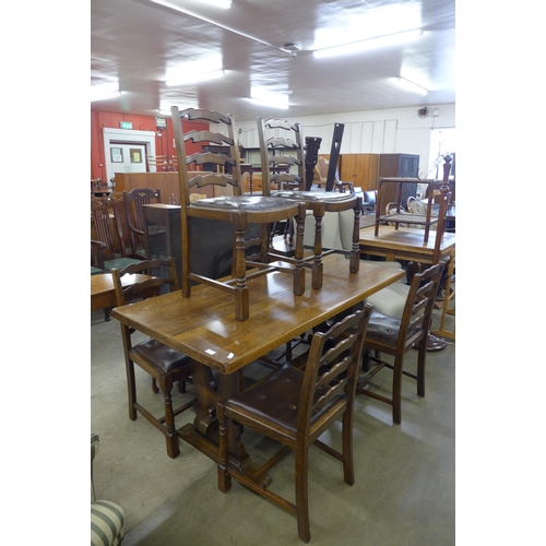 217 - An oak refectory table and six elm ladderback chairs