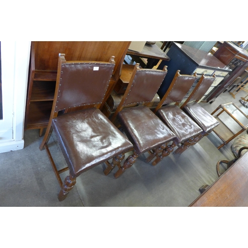 223 - A set of four oak and brown leather dining chairs