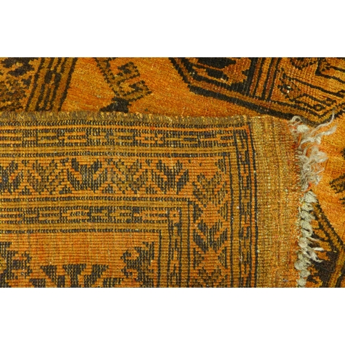 246 - A hand knotted Afghan mustard ground rug