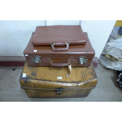 255 - A tin steamer trunk, a leather case and a satchel