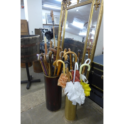 280 - Two stick stands including a collection of walking sticks and umbrellas