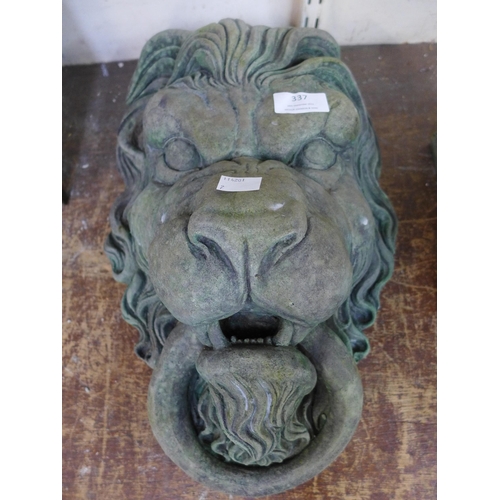 337 - A concrete wall hanging lion mask