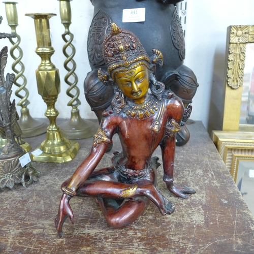 340 - An oriental bronze figure of a seated deity