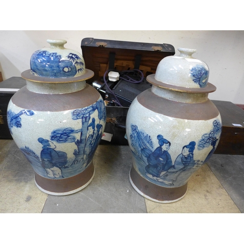 362 - A pair of oriental blue and white porcelain ginger jars and covers