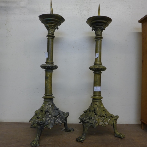 369 - A pair of brass ecclesiastical candlesticks