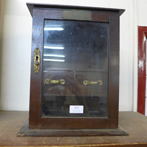 371 - A small Edward VII oak smokers cabinet