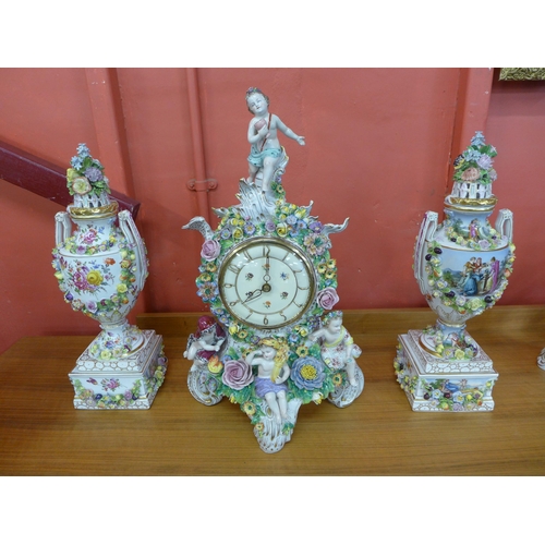 382 - A French style floral encrusted porcelain clock garniture