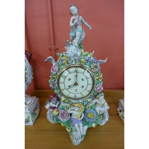 382 - A French style floral encrusted porcelain clock garniture