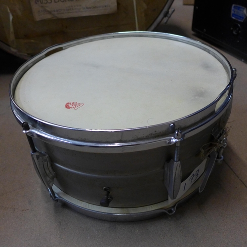 383 - A vintage bass drum, two snare drums and a small tom tom drum, drum sticks and brushes