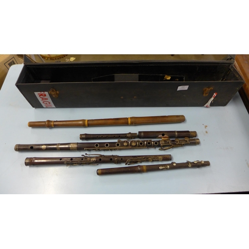 392 - A case containing two flutes and sections of flutes