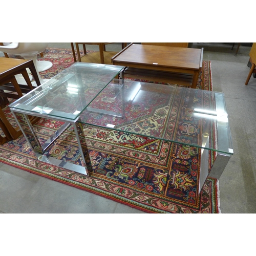 72 - A chrome and glass topped coffee table with matching occasional table