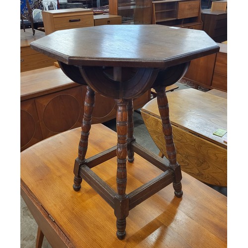 128 - An Arts and Crafts oak octagonal tavern table