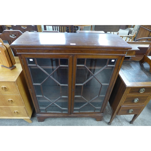 100 - A George III style mahogany two door bookcase