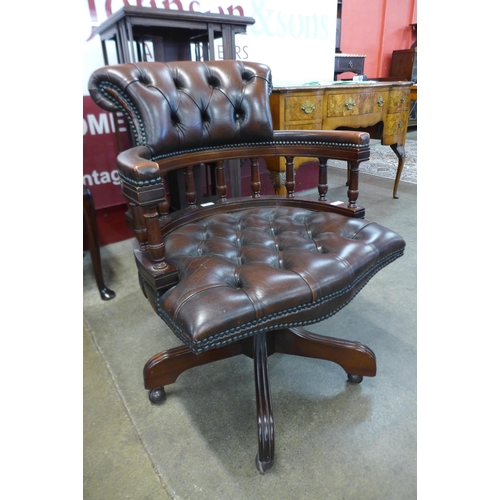 13 - A mahogany and brown leather revolving Captain's desk chair