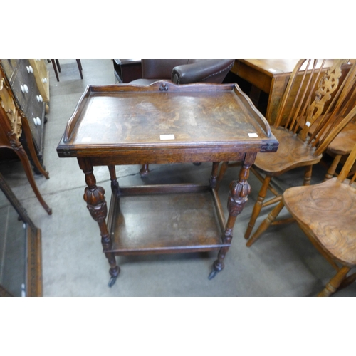 140 - An early 20th Century carved oak fold-over games table