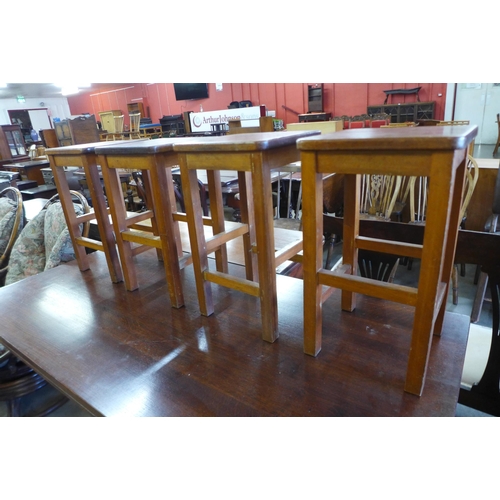 178 - A set of four beech laboratory stools