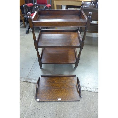 219 - An oak three tier trolley