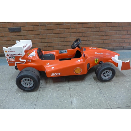 234a - A limited edition Ferrari F1 Indy ride on car, Formula 1 W/12 volt battery power - with charging lea... 