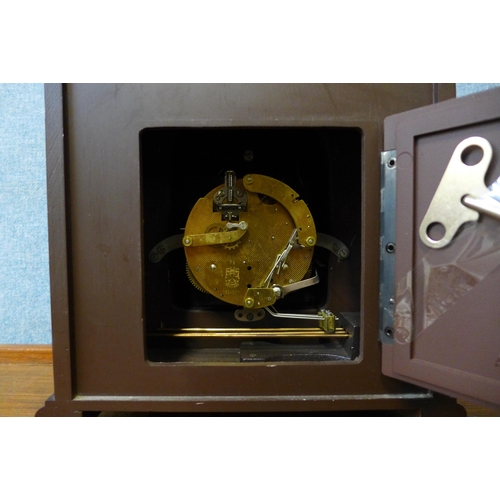 294 - A German Hermle walnut mantle clock with moonphase rolling dial