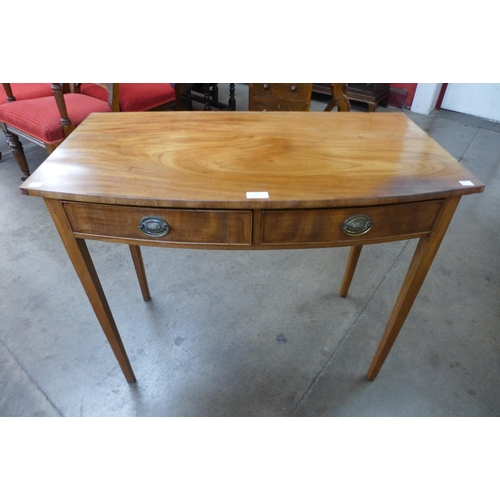 7 - A George III mahogany bow front two drawer side table