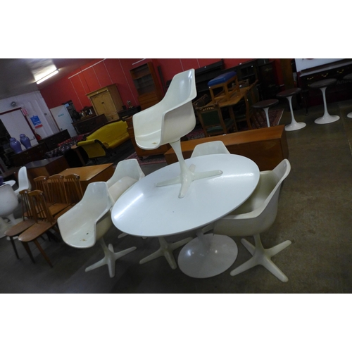 75 - An Arkana white laminate tulip shaped table and six chairs, designed by Maurice Burke