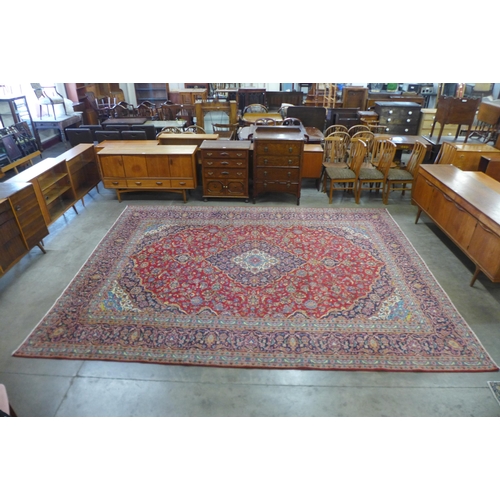 96 - A Persian red ground rug, 398 x 300cms