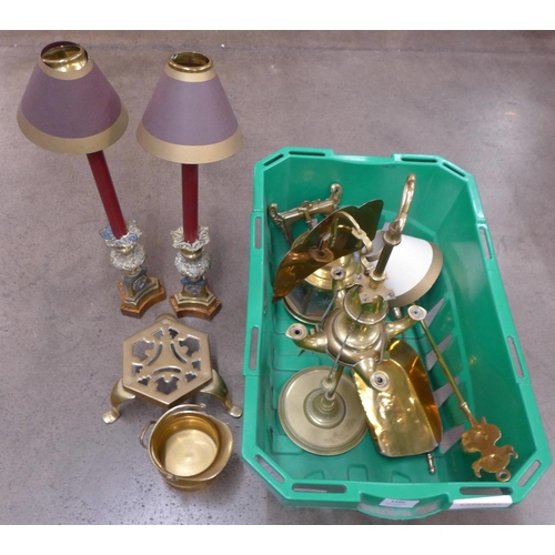 1105 - A brass four arm oil lamp with shield, a pair of brass candlesticks on wood base with removable top,... 