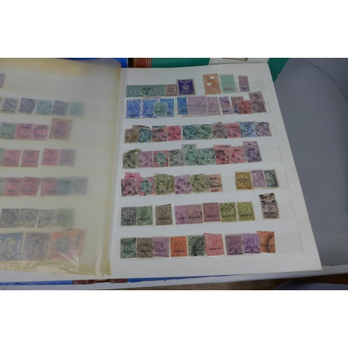 669 - Three stamp albums including Malaysia, India, Guernsey, Isle of Man, etc.